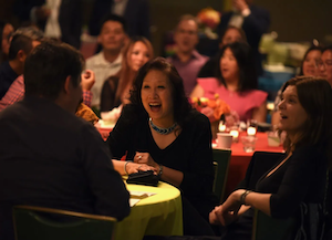 People laughing at an evening event