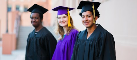 Three students in graduation caps and gowns
