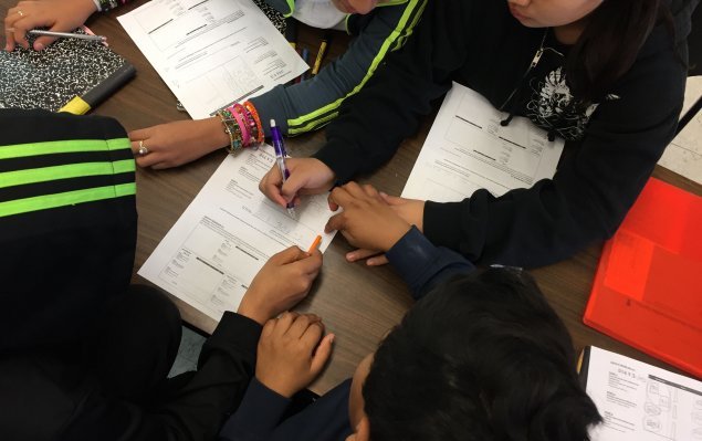 three students work on math problem