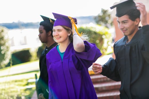 Three students in graduation caps and gowns
