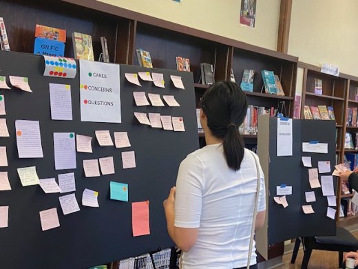 A participant looks at suggestions at a High School Task Force Community Listening Session.