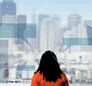 Person facing away views city. Vision 2025 cover image.