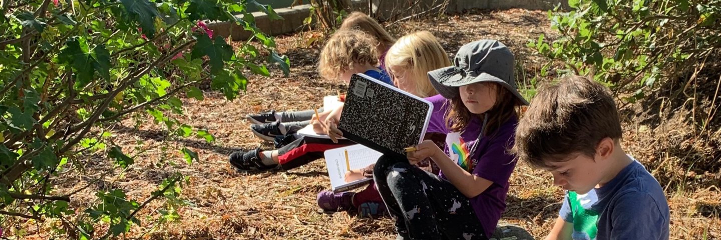 children in garden reading