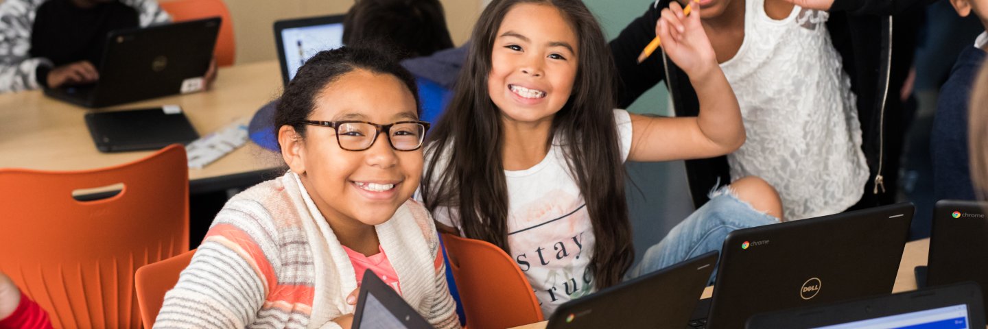 three happy girls on chromebooks
