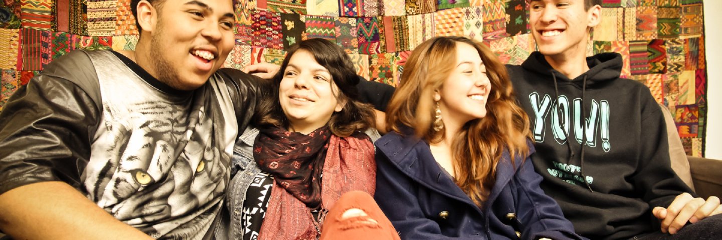 Health Ed - Four YOW students conversing in front of wall - interior
