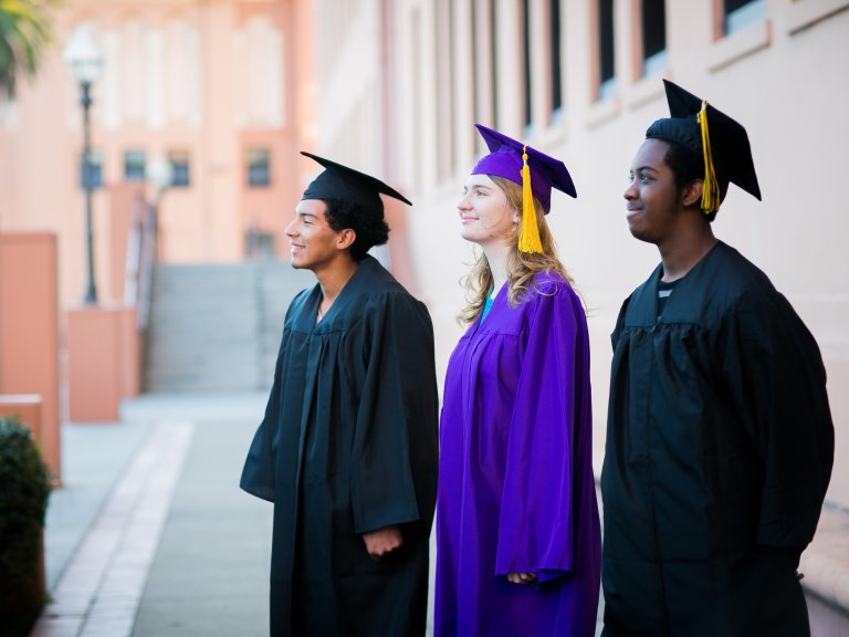 Three students in their graduation gowns