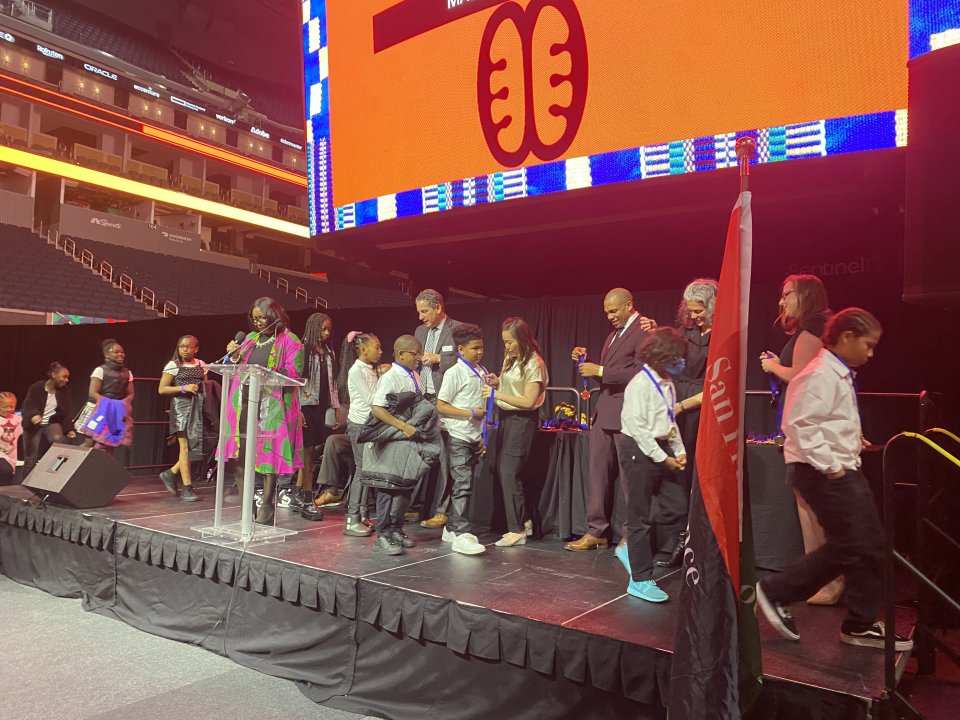 Students receiving african american honor roll on stage at Chase Center