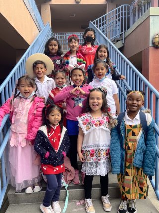 Happy diverse students on blue staircase