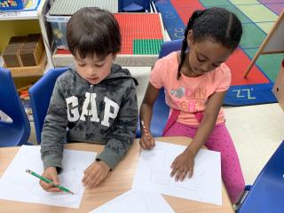Boy and girl writing at desk