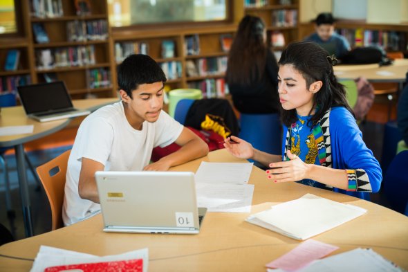High school student and teacher in library