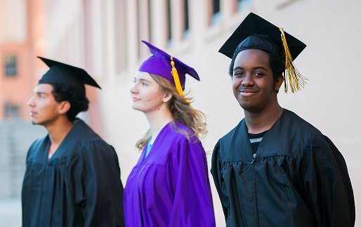 Three high school students in graduation caps and gowns