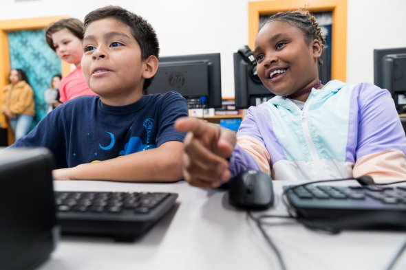 Two students working together on a computer