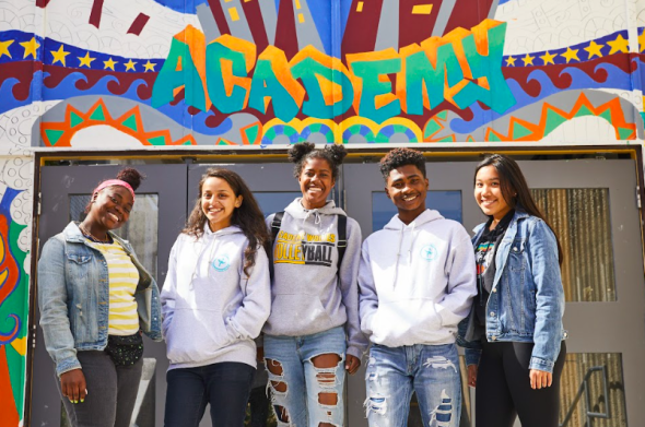five teens smiling.