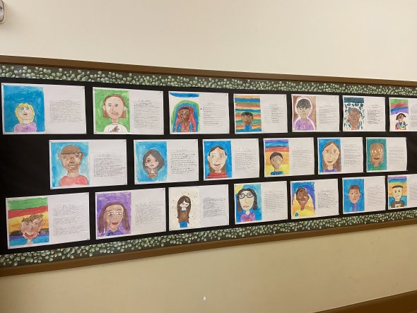 students' self portrait artwork on bulletin board