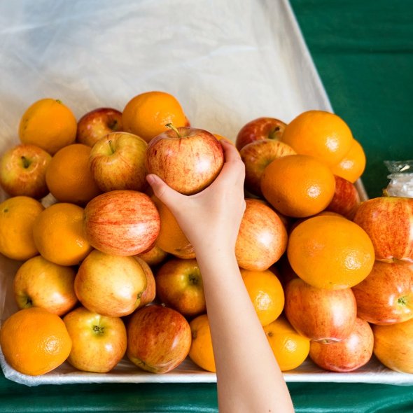 Hand reaches for apple