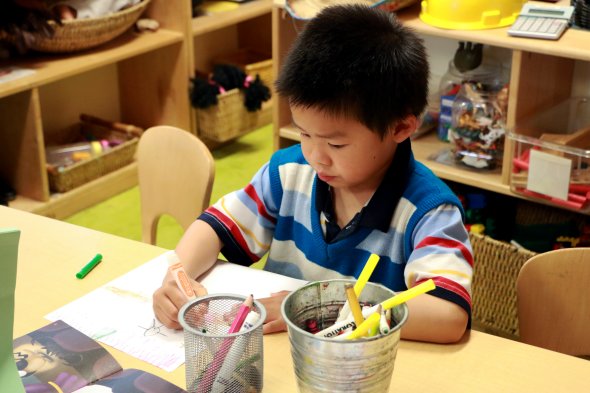 Boy drawing with marker