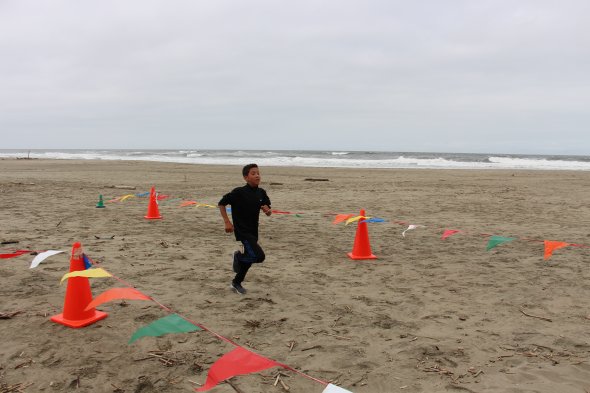 Student running at PE Beach run 