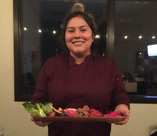 student holding platter of food