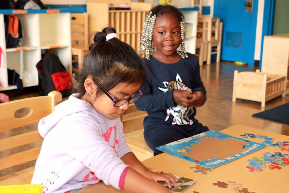 Two girls playing with puzzles
