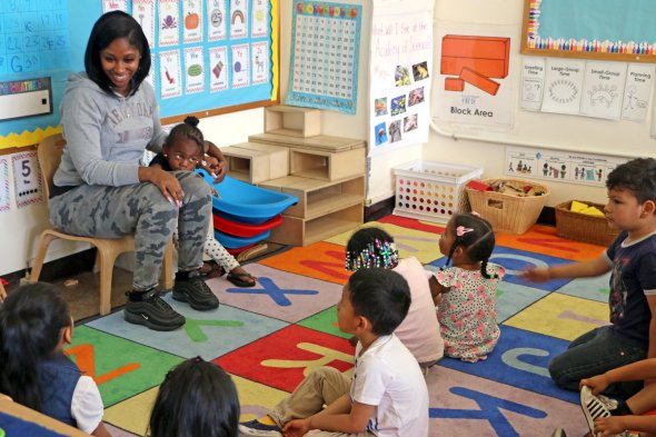 Teacher smiling at classroom of kids