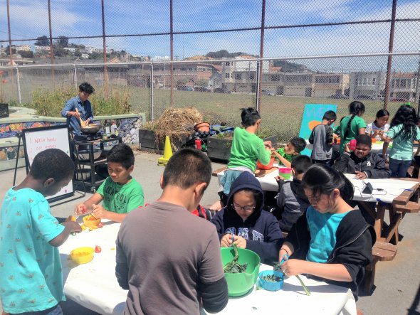 students prepping veggies in the garden