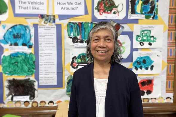 Teacher smiling at camera in her classroom