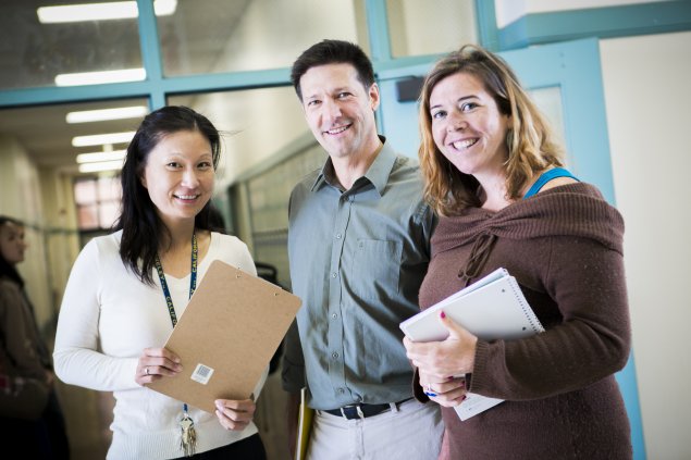 Three teachers smiling at camera