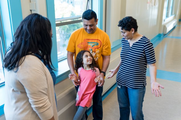 Teacher or principal with student and family