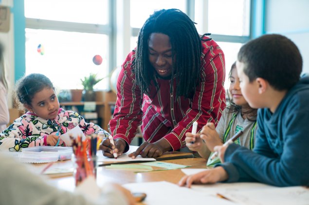 Teacher drawing with elementary school students