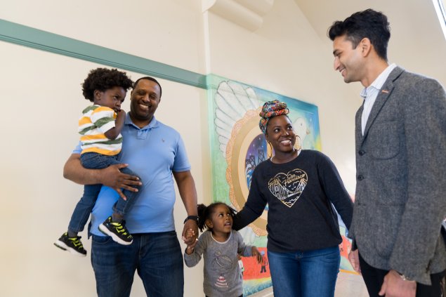 Parents or guardians talking with teacher or administrator