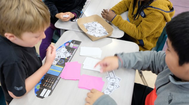 students playing a money-based game