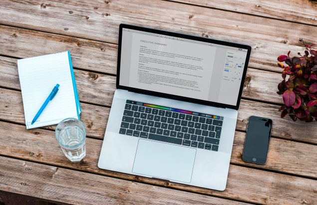 A laptop on a desk. 
