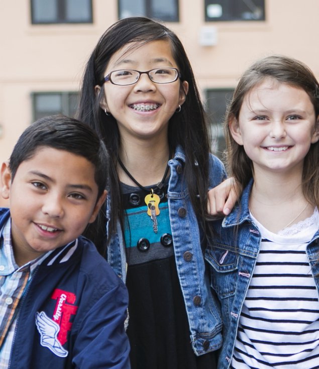Three children smiling