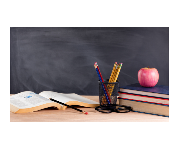 book, pencils, and an apple on a desk