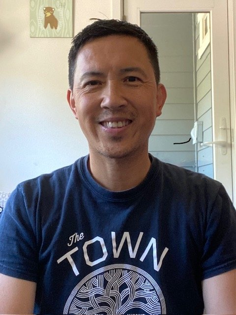 Asian man with short black hair smiling 