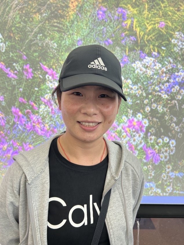 Smiling Asian woman with hat on