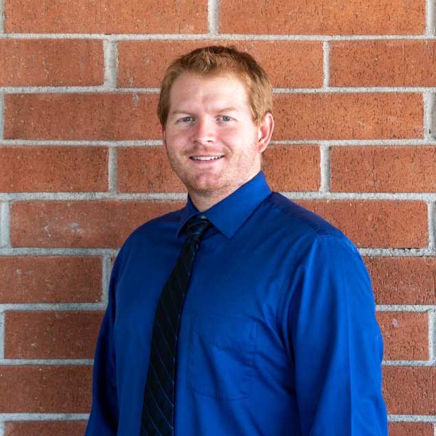 Smiling man with short red hair
