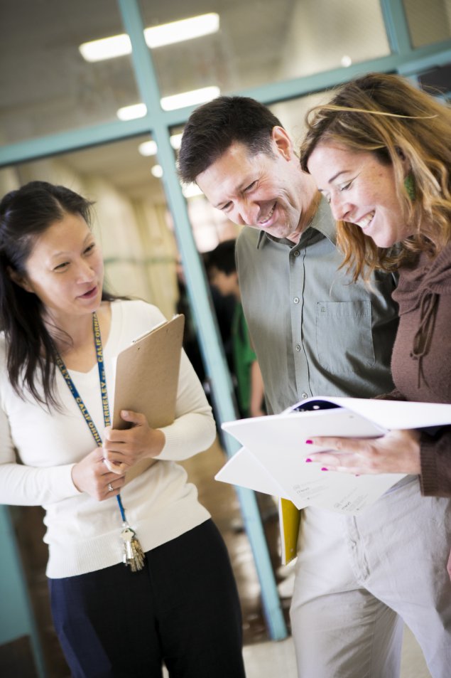 Three administrators conferring together