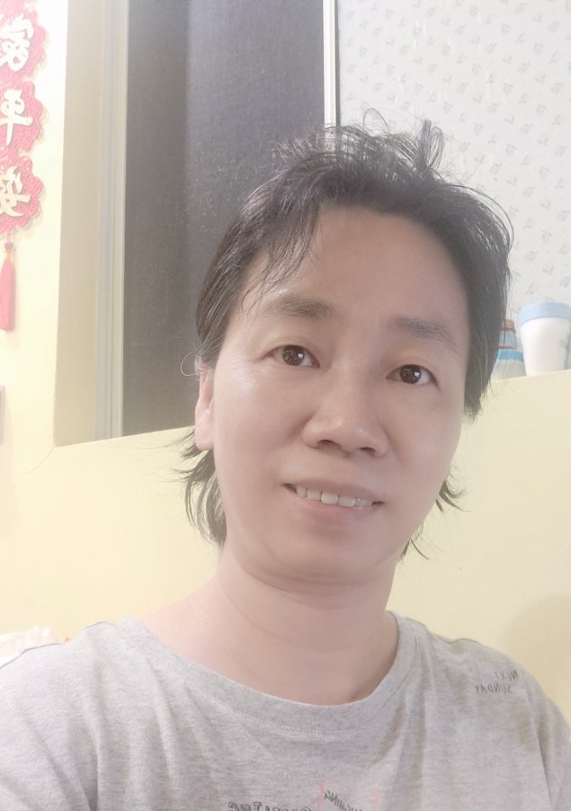 Ivy Hu - woman with short hair smiling 