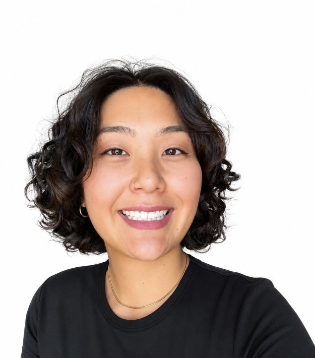 Smiling asian woman with curly brown hair
