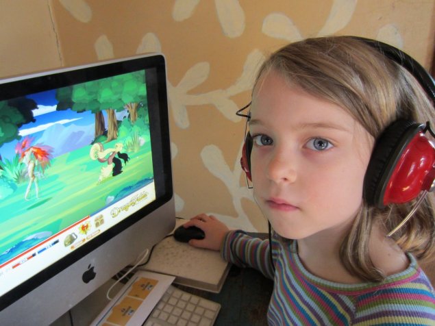 Kid reads on computer
