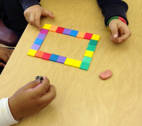 Students using tiles to find the perimeter of a rectangle