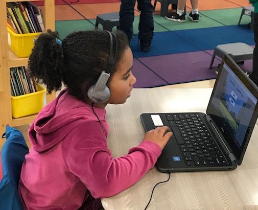 First grade girl using chromebook