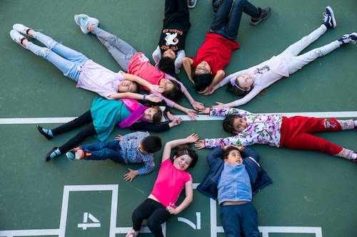 Children lying in a cirle