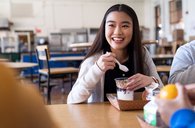 Female student eats school lunch