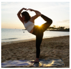 Woman doing yoga in the beach
