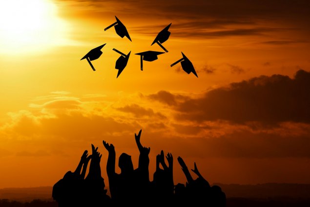 Graduates throwing their caps in the air