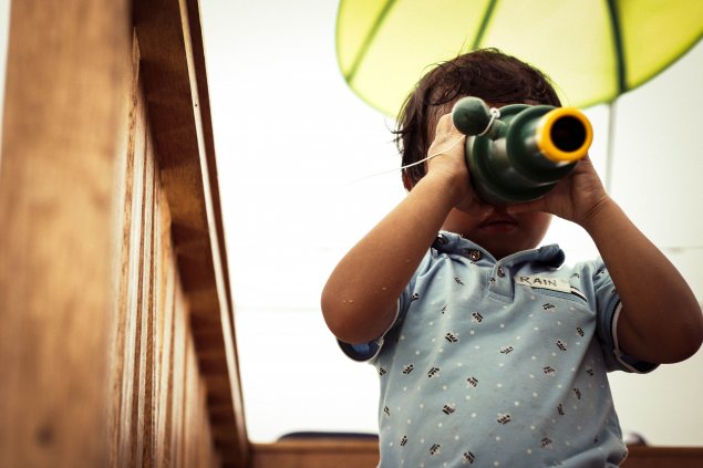 Child looking through spy glass